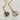Moon and sun pendant necklace made with 18kt, non-tarnish,  waterproof metal. The moon and sun symbolize balance and harmony between opposing forces, often representing the duality of life. The sun typically embodies warmth, energy, and life, while the moon represents intuition, peace, and nurturing. These celestial bodies, when combined, signify the complementary nature of these qualities and can symbolize a deep, enduring connection.