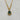 A mixed chain necklace with an emerald green oval pendant and sparkling crystal accents. A chic statement necklace for day or night.