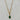 A mixed chain necklace with an emerald green oval pendant and sparkling crystal accents. A chic statement necklace for day or night.
