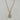 A gold-tone pendant necklace featuring a circular medallion with an angel and heart design, accented with small clear stones, hanging from a gold chain.