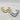 Gold-tone and silver-tone double layer cuff bracelet with a polished finish and sculptural curved V design.