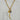 Gold-tone mixed-link statement necklace featuring a long textured curved horn pendant, celestial sun and moon coin, faceted labradorite gemstone, and crystal charm.