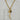 Gold-tone mixed-link statement necklace featuring a long textured curved horn pendant, celestial sun and moon coin, faceted labradorite gemstone, and crystal charm.