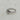 A silver ring with a rough, organic-shaped bezel holding a clear oval gemstone.