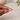 A gold ring with a rough, organic-shaped bezel holding a clear oval gemstone.