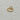 Gold-tone open heart ring with a polished sculptural design displayed on a light marble surface.