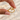 Gold-tone open heart ring with a polished sculptural design displayed on a light marble surface.