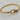 Gold twisted cable bracelet with buckle-inspired clasp and sparkling crystal accents.