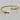 Gold twisted cable bracelet with sculptural hook-and-loop closure and sparkling crystal accents.