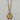A gold-tone pendant necklace featuring a circular medallion with an angel and heart design, accented with small clear stones, hanging from a gold chain.