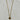 A gold chain necklace with a small oval pendant featuring a dark brown tiger's eye stone.