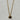A gold chain necklace with a small oval pendant featuring a dark brown tiger's eye stone.