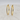 A pair of gold hoop earrings with a textured, diamond-like paved edge.