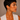 A woman with a short haircut wearing a pair of organic-shaped silver stainless steel hoop earrings with a textured, wavy finish, non-tarnish and waterproof. 