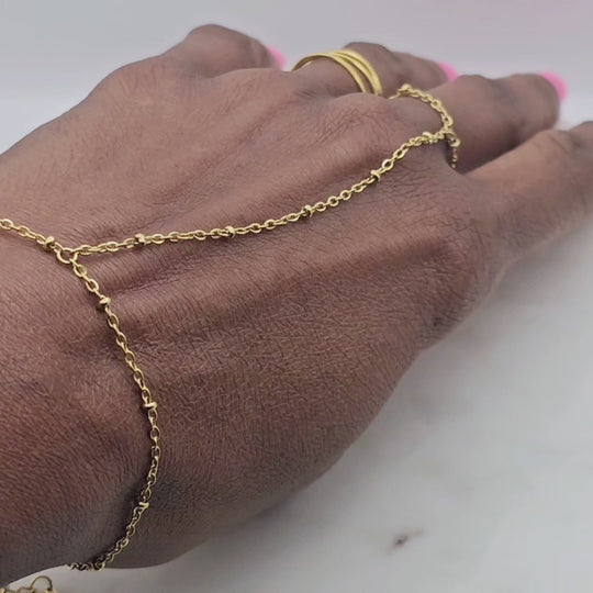 18kt gold stainless steel, non-tarnish hand chain bracelet style. It's adjustable. This unique bracelet can be worn alone or paired with multiple rings and permanent jewelry bracelets.