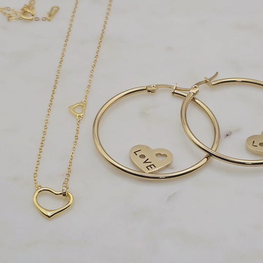 Non-tarnish, waterproof 18kt gold plated statement hoop earrings. The two small hearts with the word love in them make these hoop earrings unique, sophisticated, and fashionable. If you love unique earrings, you'll love these.