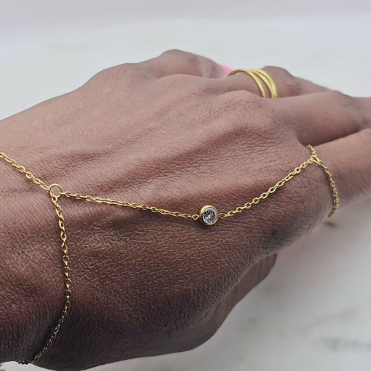 18kt gold stainless steel, non-tarnish hand chain bracelet style with a small clear cz stone. It's adjustable. This unique bracelet can be worn alone or paired with multiple rings and permanent jewelry bracelets.