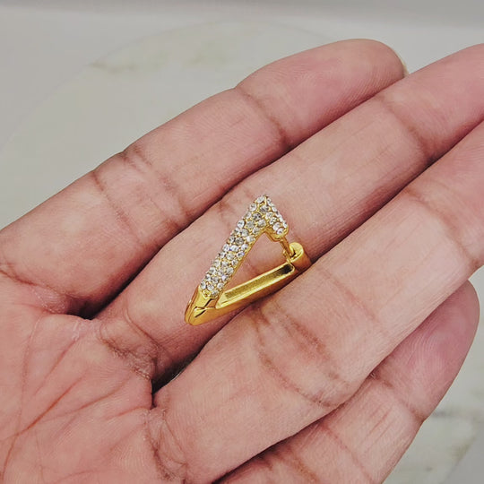 Non-tarnish, waterproof 18kt gold plated triangle shaped huggie style earrings with clear cz stones. Unique style and shape earrings. They can be worn with any outfit and can complement almost any necklace style.