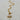 Gold-tone toggle necklace with a rectangular link chain, clear teardrop crystal, and sparkling celestial sunburst pendant.