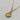 A gold pendant necklace featuring a circular medallion with an angel and heart design, accented with small clear cz stones.