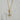 Gold-tone toggle necklace with a rectangular link chain, clear teardrop crystal, and sparkling celestial sunburst pendant.