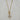 Gold-tone toggle necklace with a rectangular link chain, clear teardrop crystal, and sparkling celestial sunburst pendant.