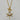 Gold-tone toggle necklace with a rectangular link chain, clear teardrop crystal, and sparkling celestial sunburst pendant.