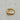 A gold signet ring with a teardrop-shaped clear stone.