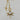 Gold-tone toggle necklace with a rectangular link chain, clear teardrop crystal, and sparkling celestial sunburst pendant.