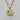A gold pendant necklace with a detailed round medallion inspired by the night sky, accented with sculpted stars, a sparkling crystal crescent, and a small striking green aventurine cabochon accent.