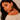 A close-up lifestyle shot of a woman wearing a pair of large, round leopard-print earrings l.