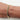 A close-up of a person's wrist wearing a slim gold bangle bracelet with a black inlay.