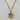 A gold pendant necklace with a detailed round medallion inspired by the night sky, accented with sculpted stars, a sparkling crystal crescent, and a small striking green aventurine cabochon accent.