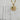 A gold pendant necklace with a detailed round medallion inspired by the night sky, accented with sculpted stars, a sparkling crystal crescent, and a small striking green aventurine cabochon accent.