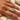 Sculptural two-tone gold and silver open wrap ring with curved wave design.