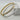Two slim bangle bracelets, one gold-toned and one silver-toned, both featuring a channel-set row of clear rectangular stones, displayed on a light gray surface.