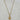 A gold pendant necklace featuring a circular medallion with an angel and heart design, accented with small clear cz stones.